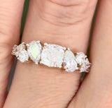 Yellow gold cushion, pear shape and round lab diamond ring. Prongs are white gold.