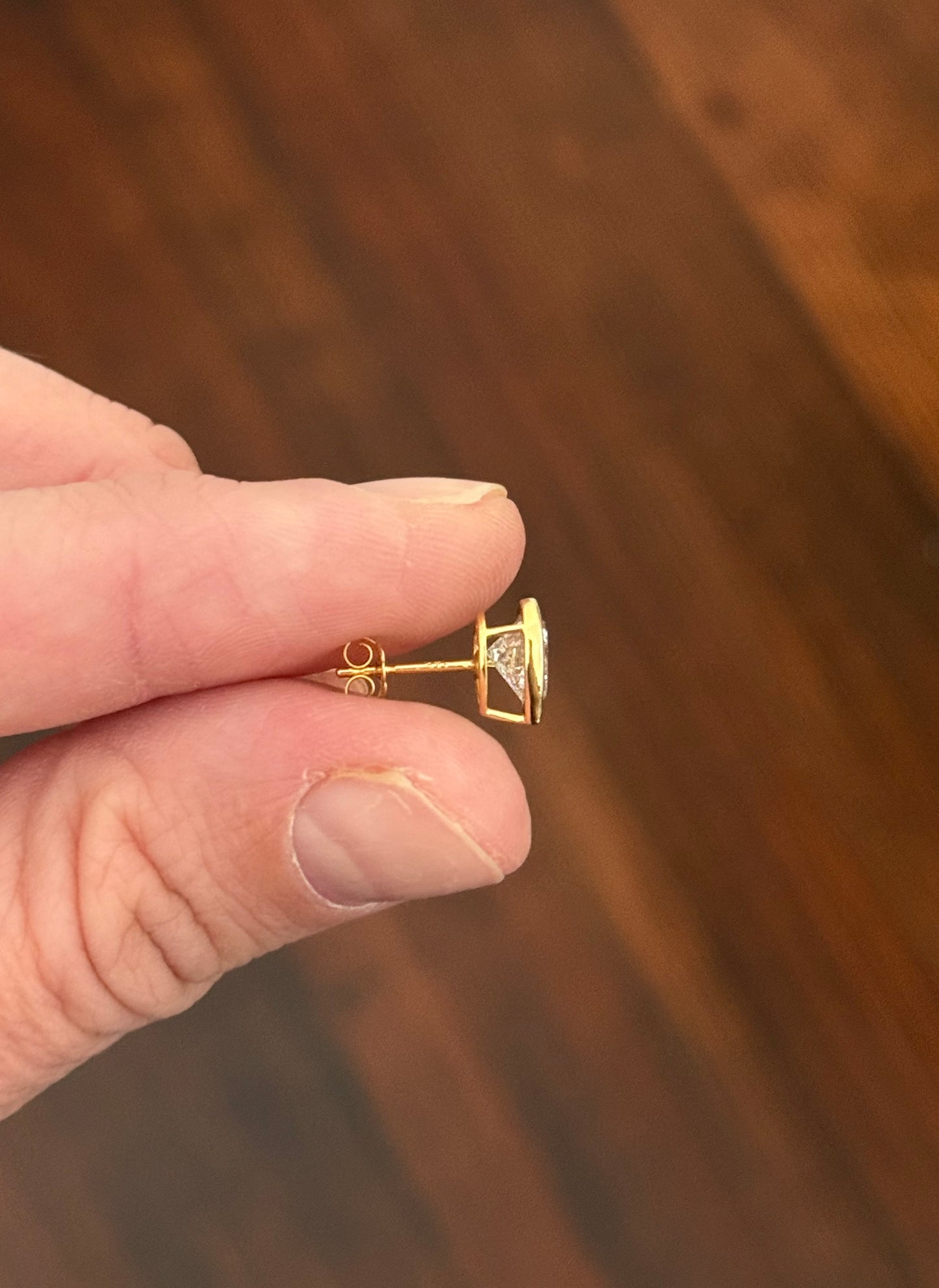 Yellow gold bezel set heart shape lab diamond stud earrings. Tops of bezel settings are white gold.