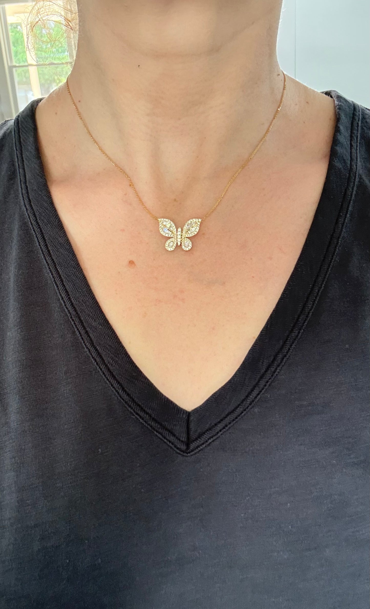 Butterfly necklaces with baguette and round diamonds available in white and yellow gold