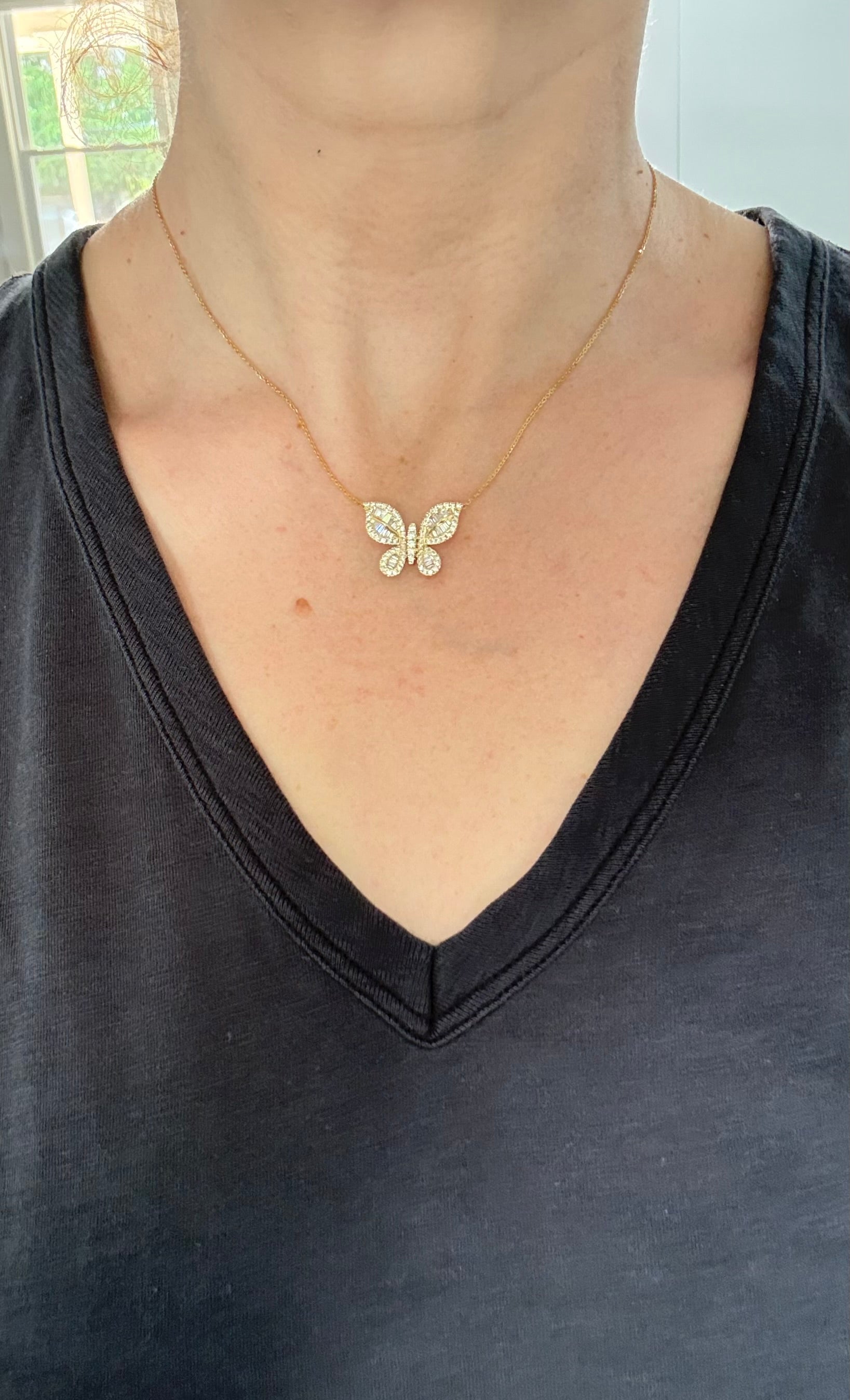 Butterfly necklaces with baguette and round diamonds available in white and yellow gold