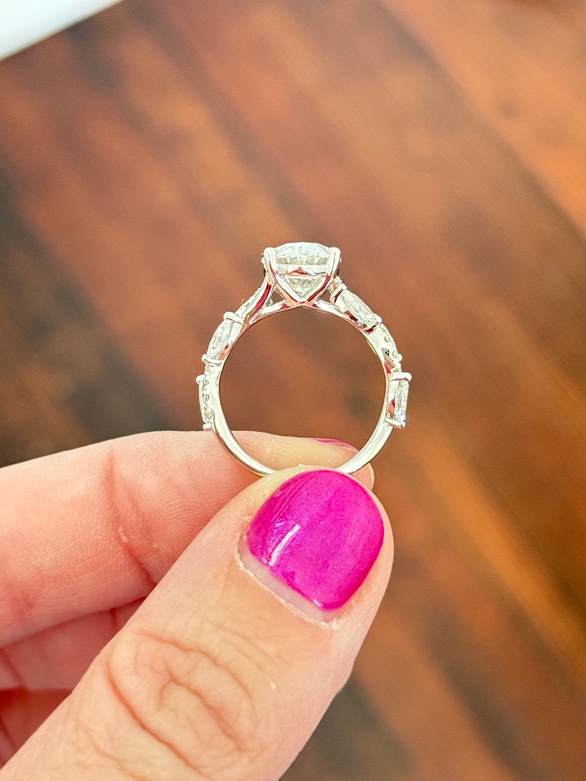 White gold oval, marquise and round lab diamond ring. Center stone is 3.07cts