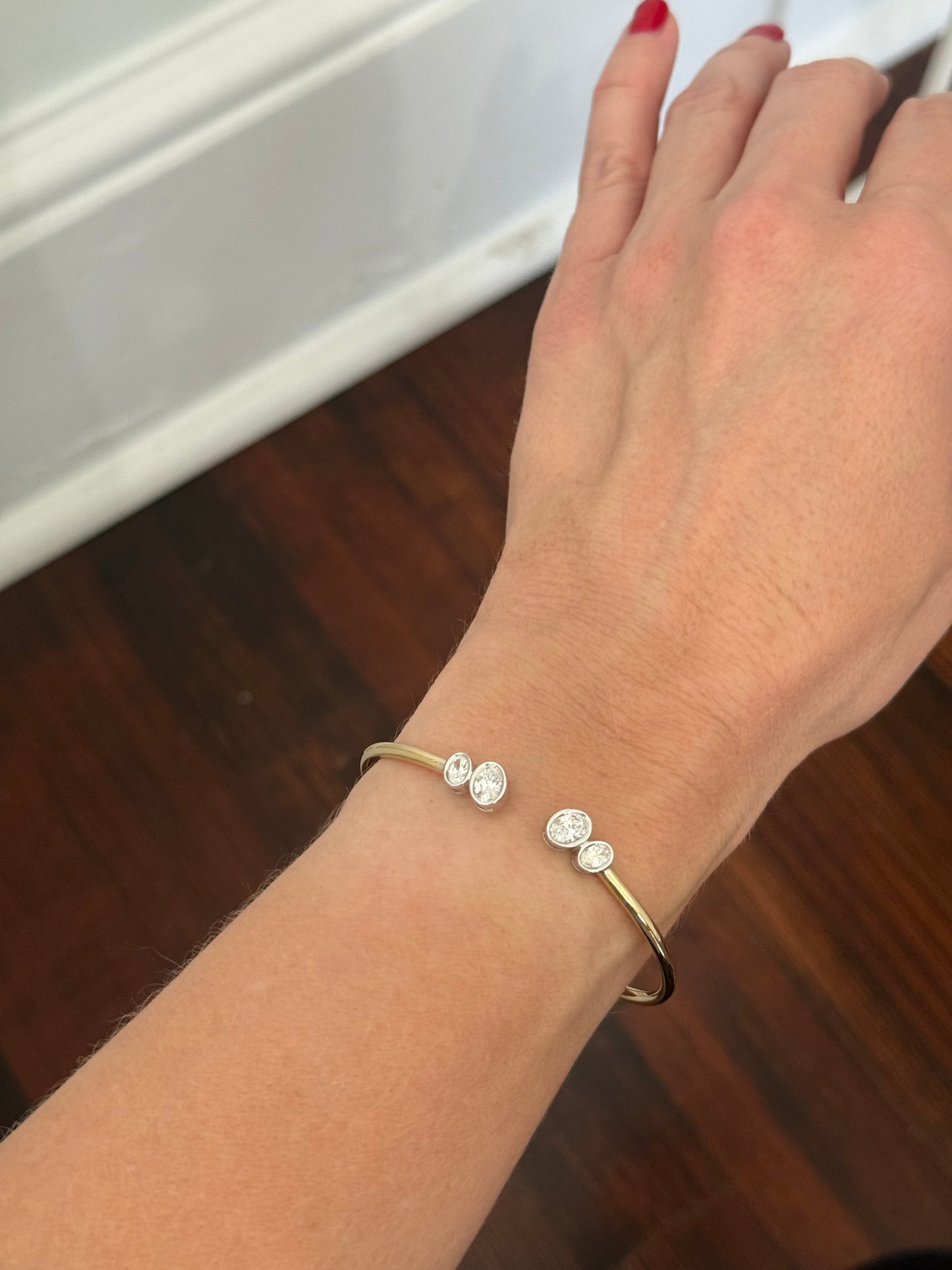 Yellow gold oval lab diamond bracelet. Lab diamond are bezel set in white gold