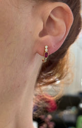 Natural diamond screw back earrings available in yellow gold with rubies and white gold with sapphires