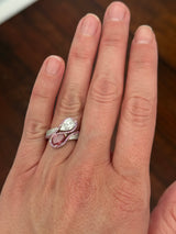 White gold pear shape and round pink and white lab diamond ring. Pink lab diamonds are set in rose gold.