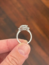 White gold emerald cut, trapezoid, and round lab diamond ring. Center stone is 4.06cts