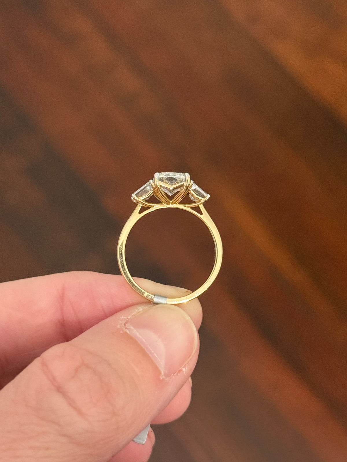 Yellow gold radiant and trapezoid lab diamond ring. Prongs are white gold.