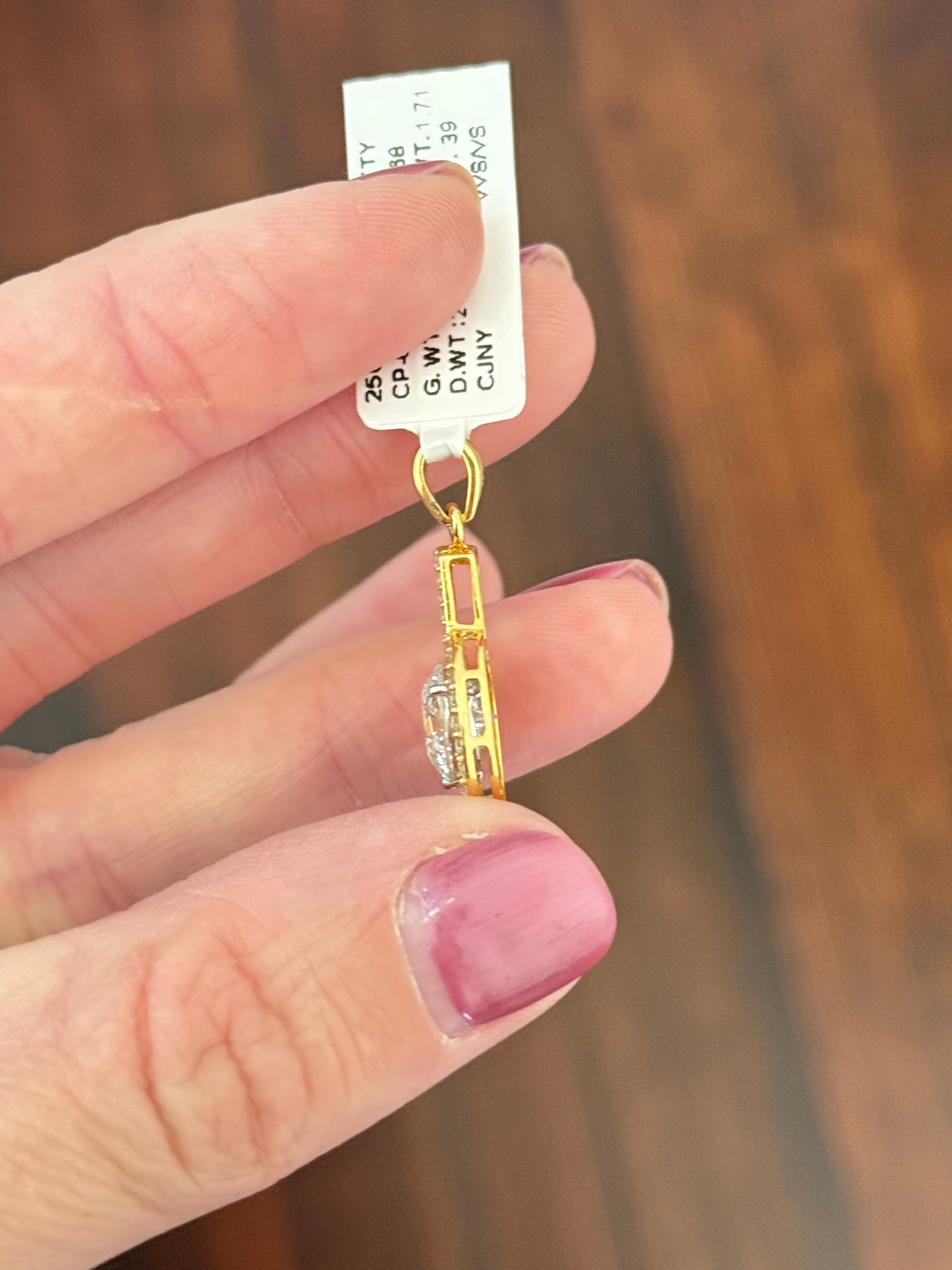 Yellow gold lab diamond pendant. Center stone is 8.0mm and set in white gold