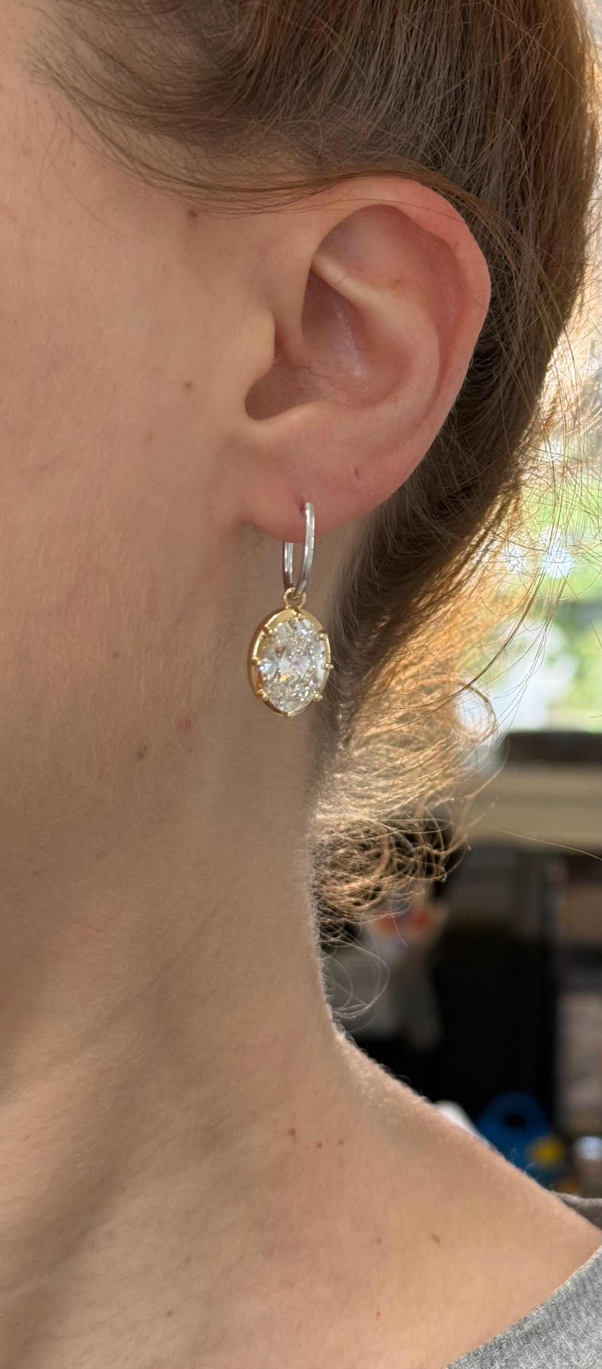 Oval lab diamond latch back earrings. Lab diamonds are set in yellow gold and earrings are white gold.