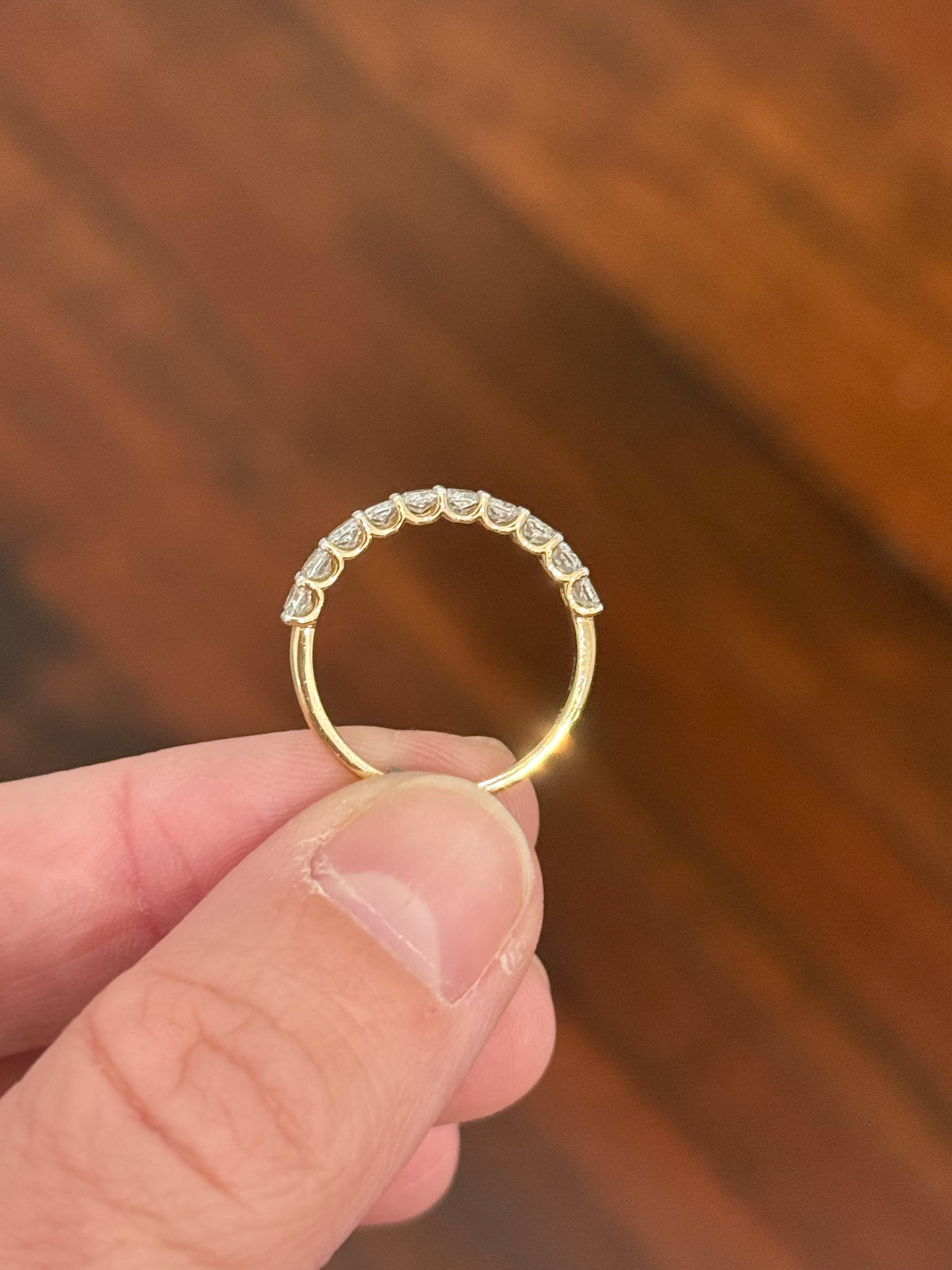 Yellow gold cushion cut lab diamond band. Prongs are white gold.