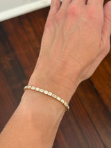 Yellow gold east west and bezel set 8.17ct emerald cut lab diamond bracelet