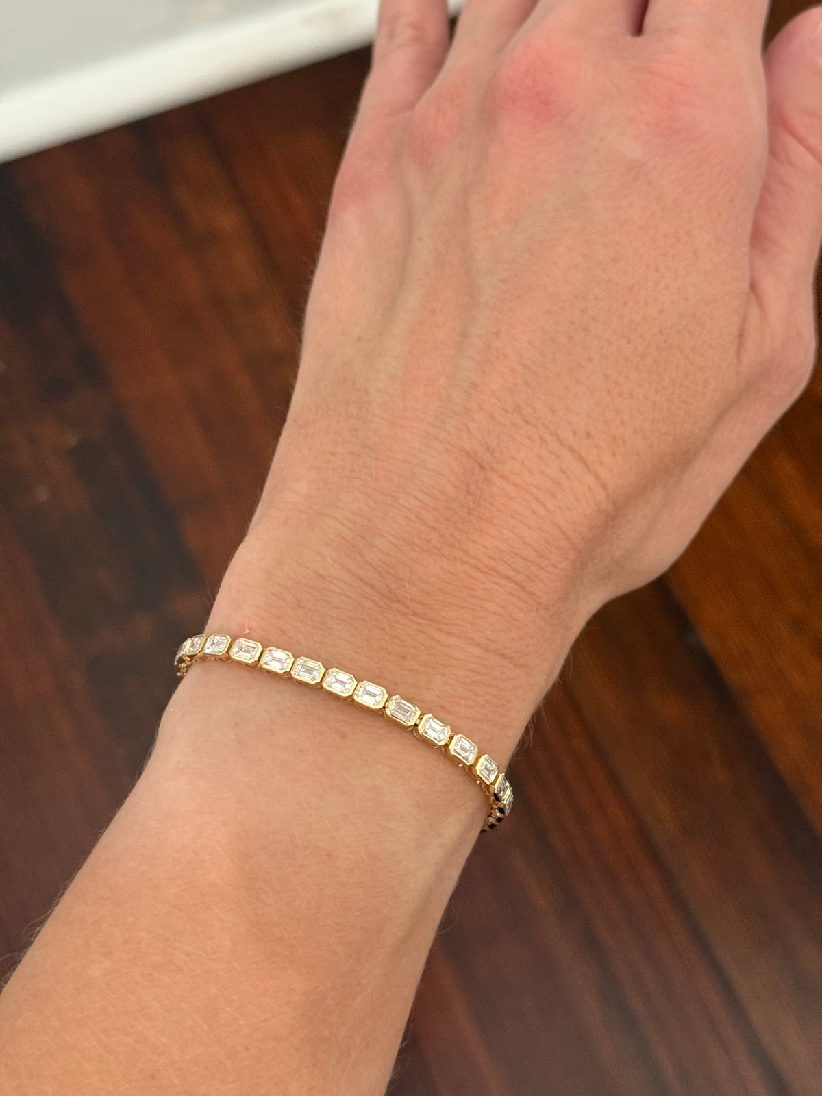 Yellow gold east west and bezel set 8.17ct emerald cut lab diamond bracelet