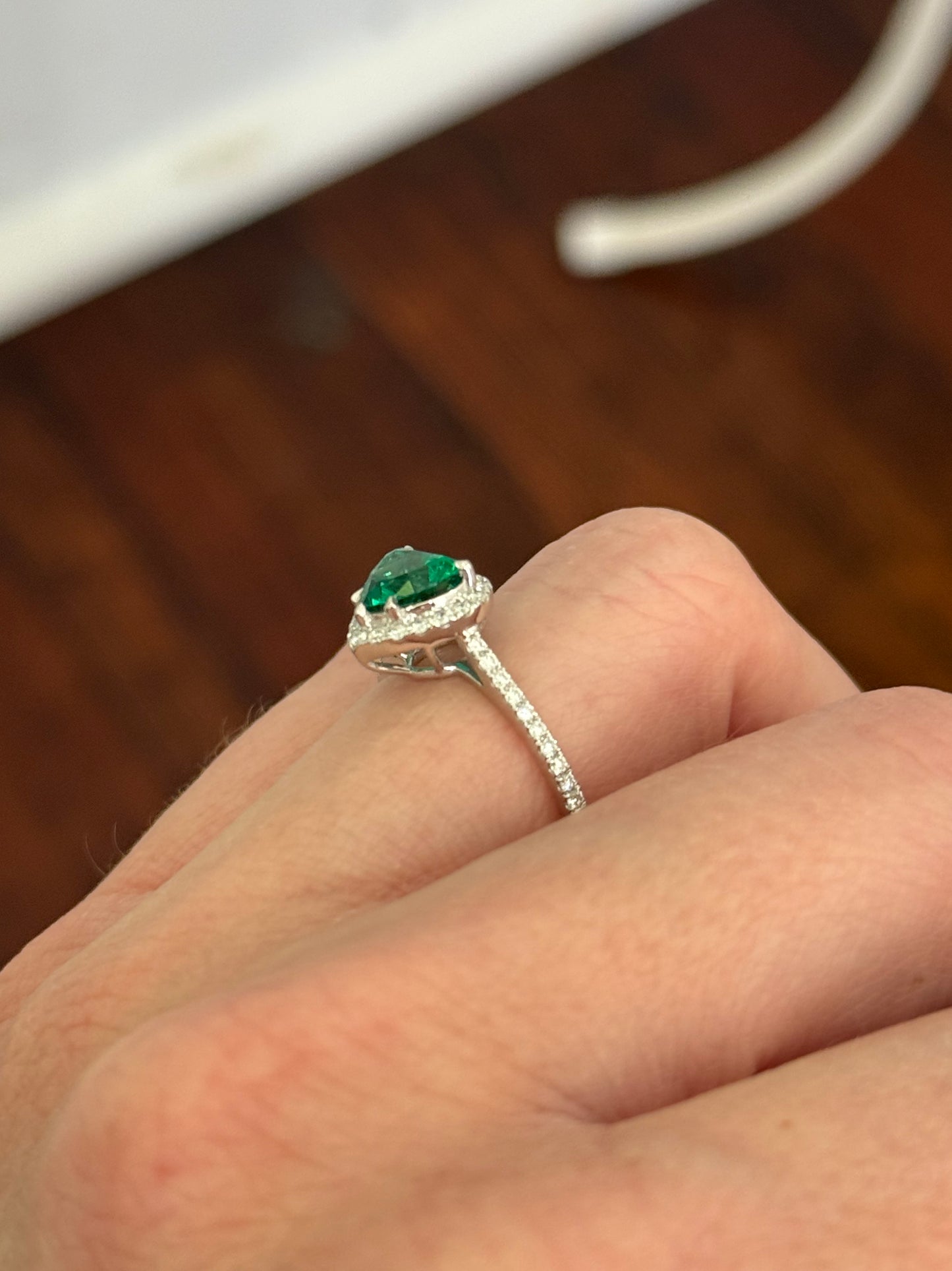 White gold heart shaped lab emerald and round lab diamond ring