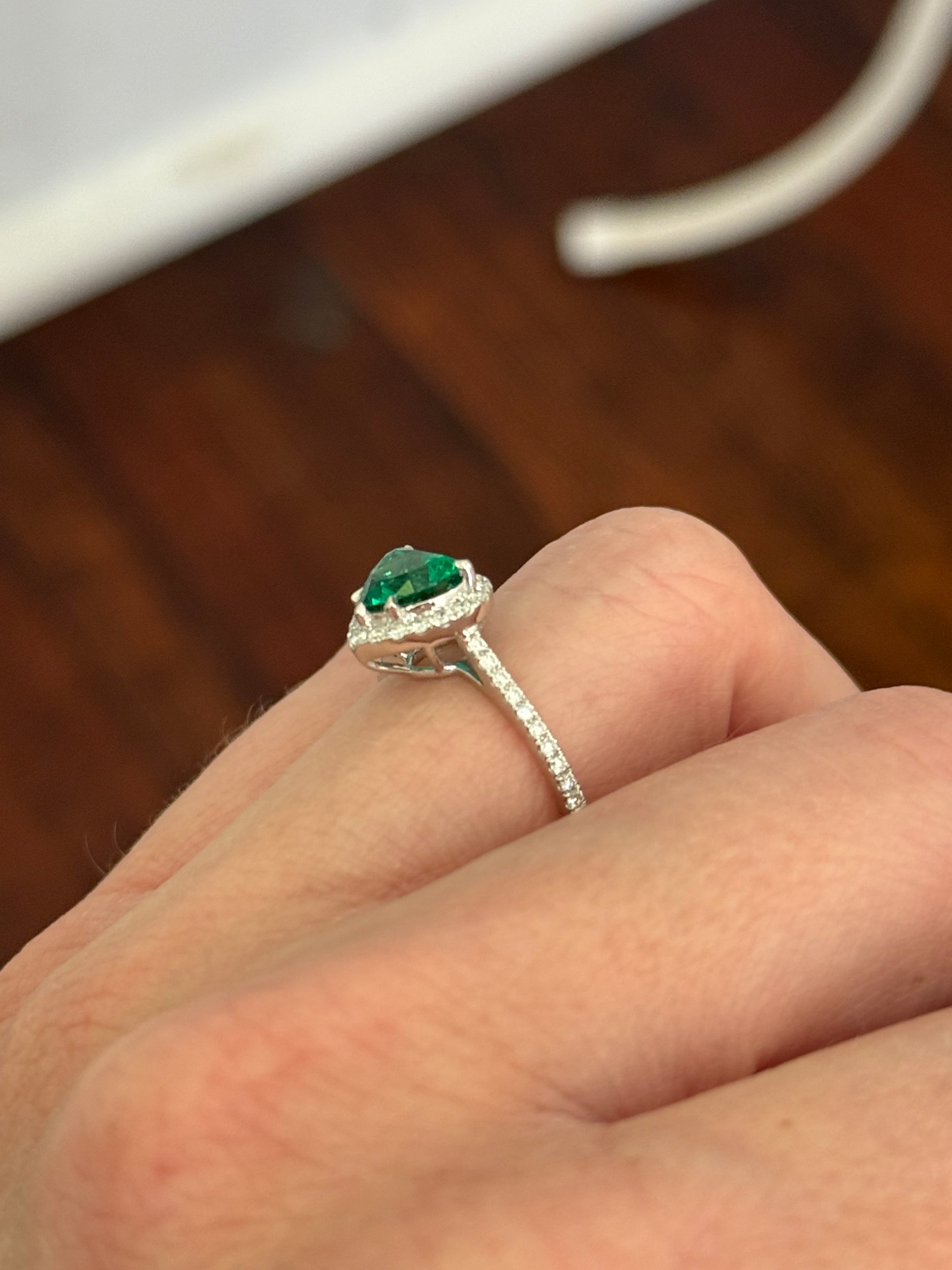 White gold heart shaped lab emerald and round lab diamond ring