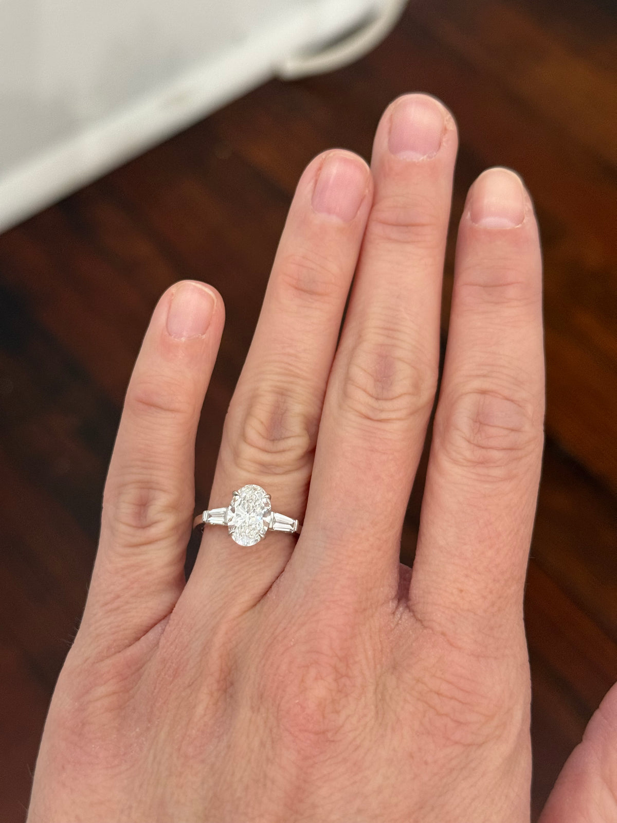 White gold IGI certified 2.02ct oval lab diamond and tapered baguette lab diamond ring. Oval measures 10.31x7.04x4.34mm