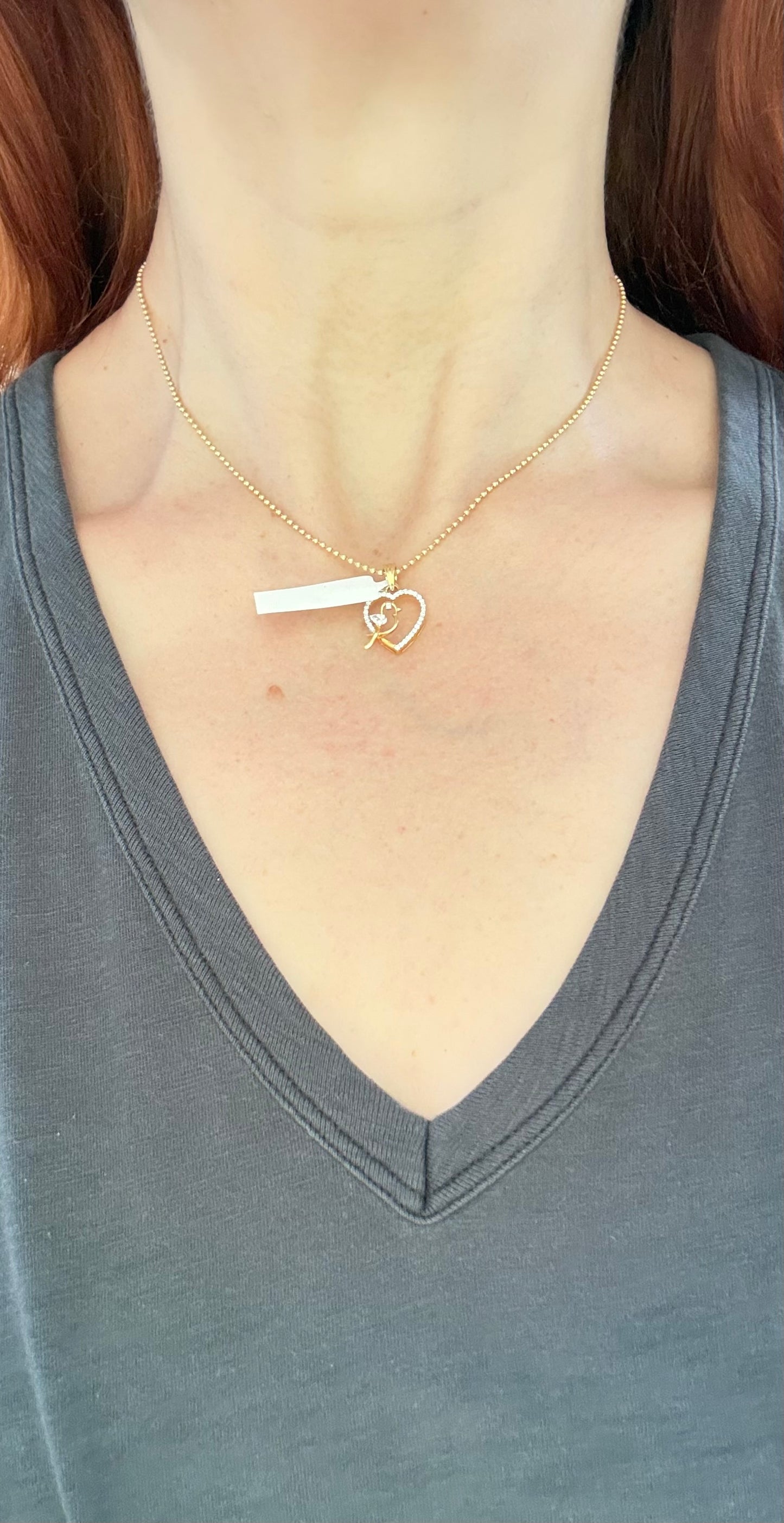 Yellow gold heart and bird pendant with pear shape and round lab diamonds