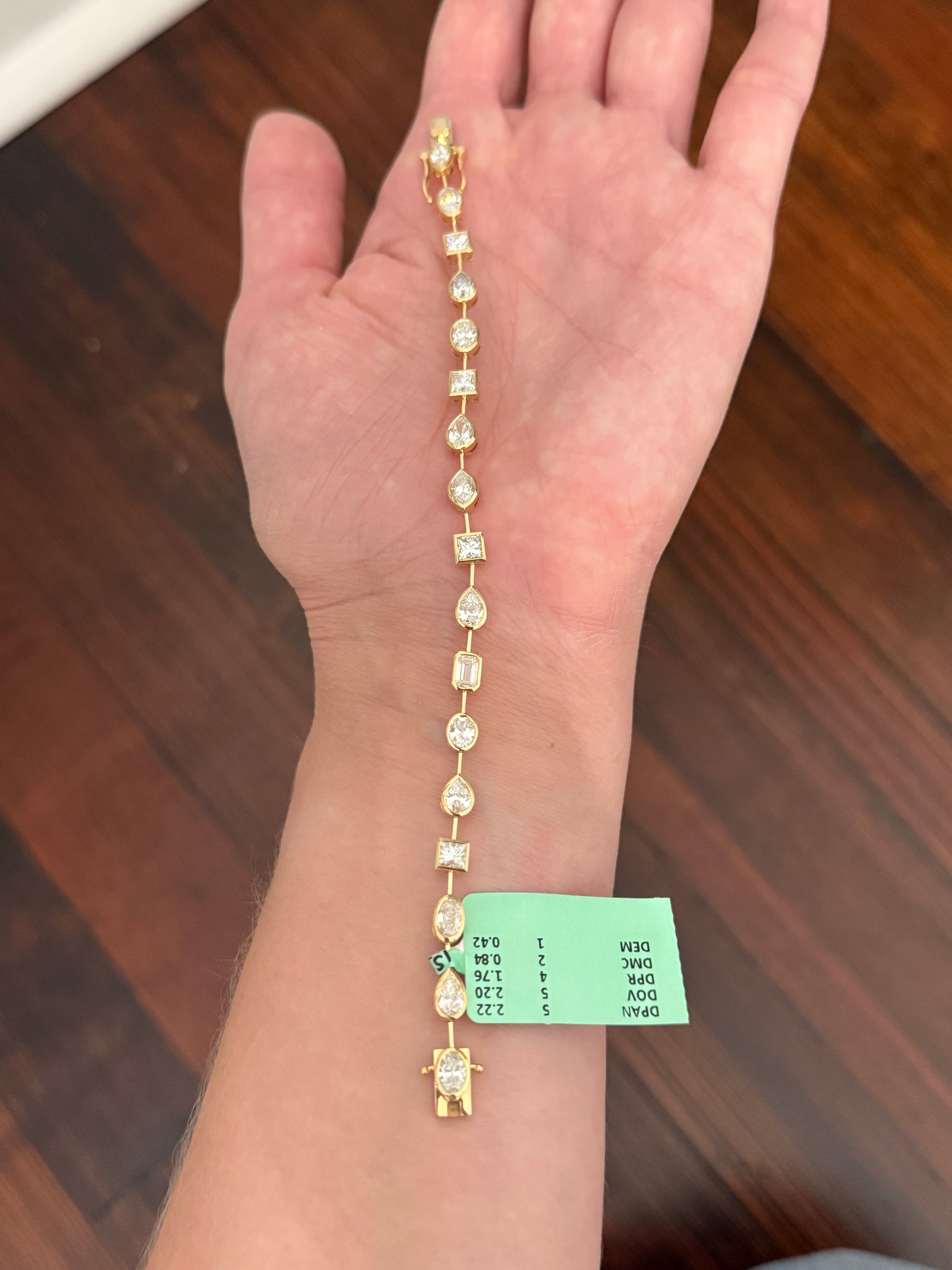 Yellow gold bezel set 7.44ct mixed shaped bracelet with oval, pear shape, marquise, princess and emerald cut natural diamonds