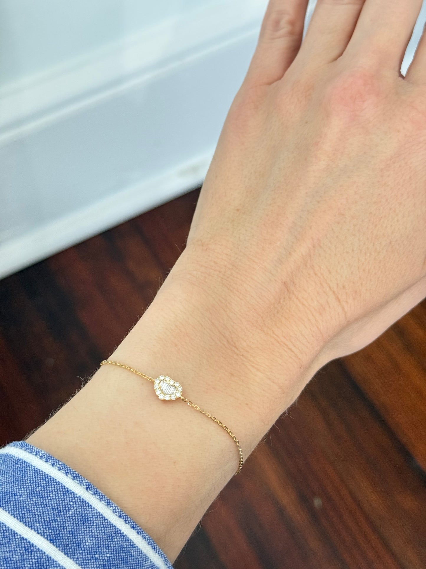 Heart chain bracelets with baguette and round diamonds available in yellow and white gold