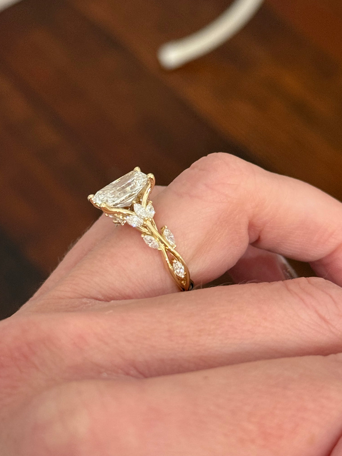 Yellow gold radiant and marquise lab diamond ring. Center stone is 3.07cts E VS1 and measures 9.8x6.7mm