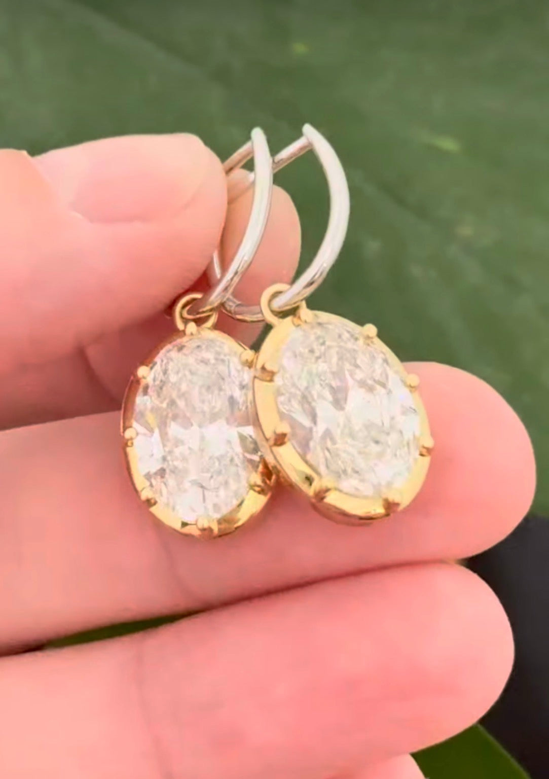 Oval lab diamond latch back earrings. Lab diamonds are set in yellow gold and earrings are white gold.