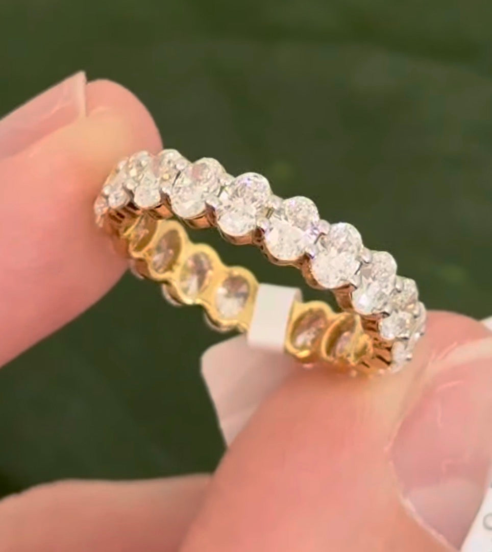 Yellow gold 3.02ct oval lab diamond eternity band. Prongs are white gold.
