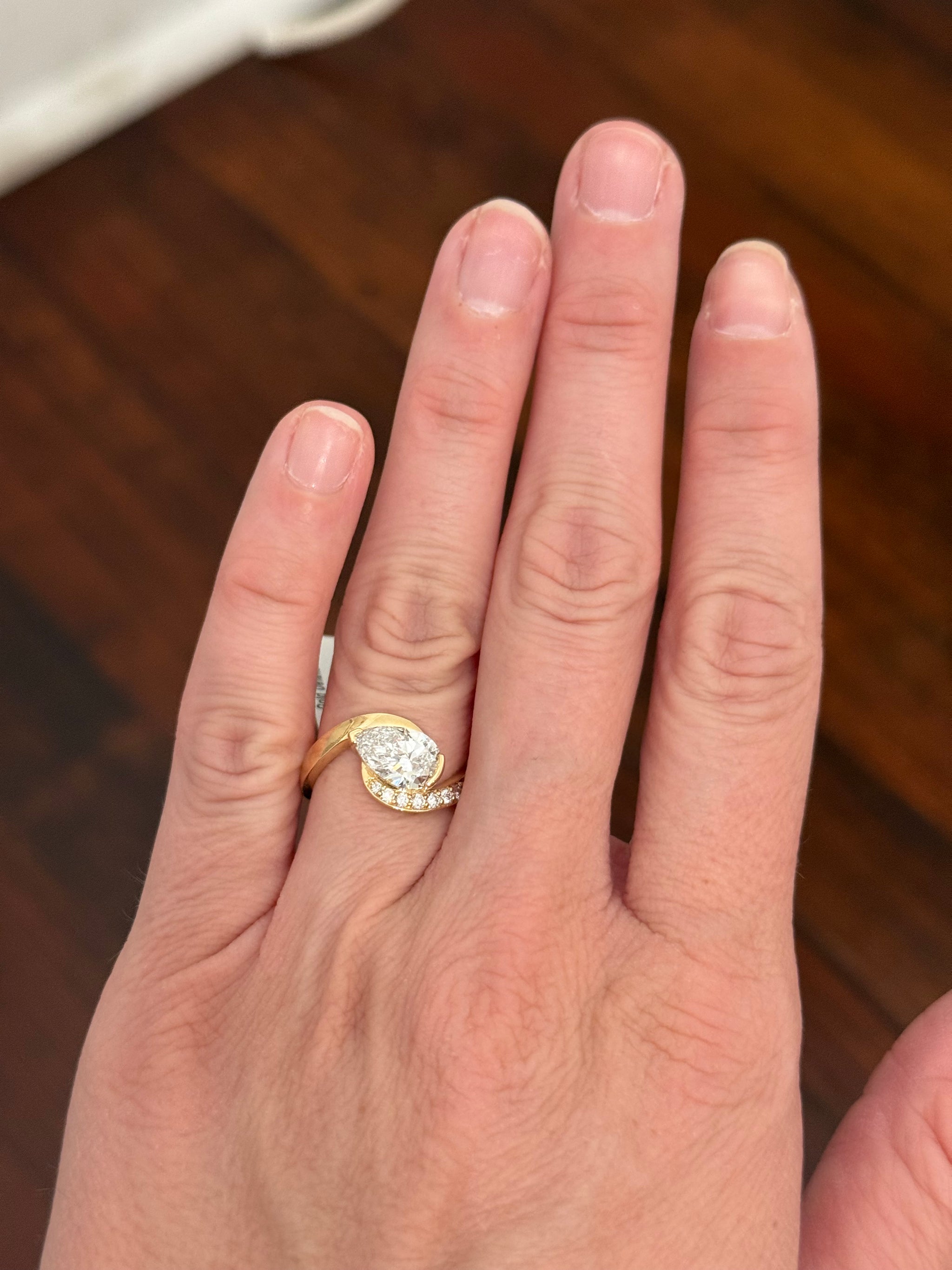 Yellow gold pear shape and round lab diamond ring. Pear shape is IGI certified and 1.54cts E VS1