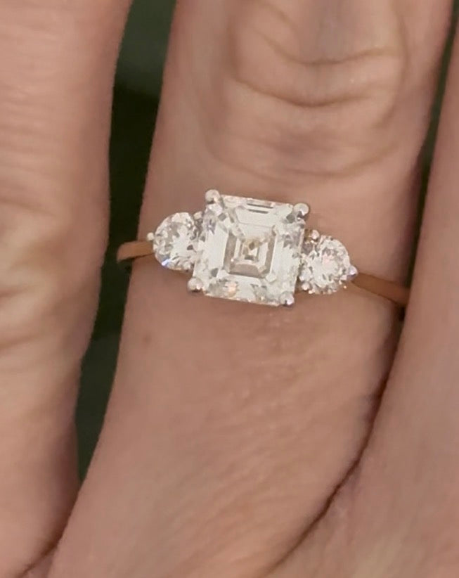 Yellow gold asscher and round lab diamond ring. Prongs are white gold.