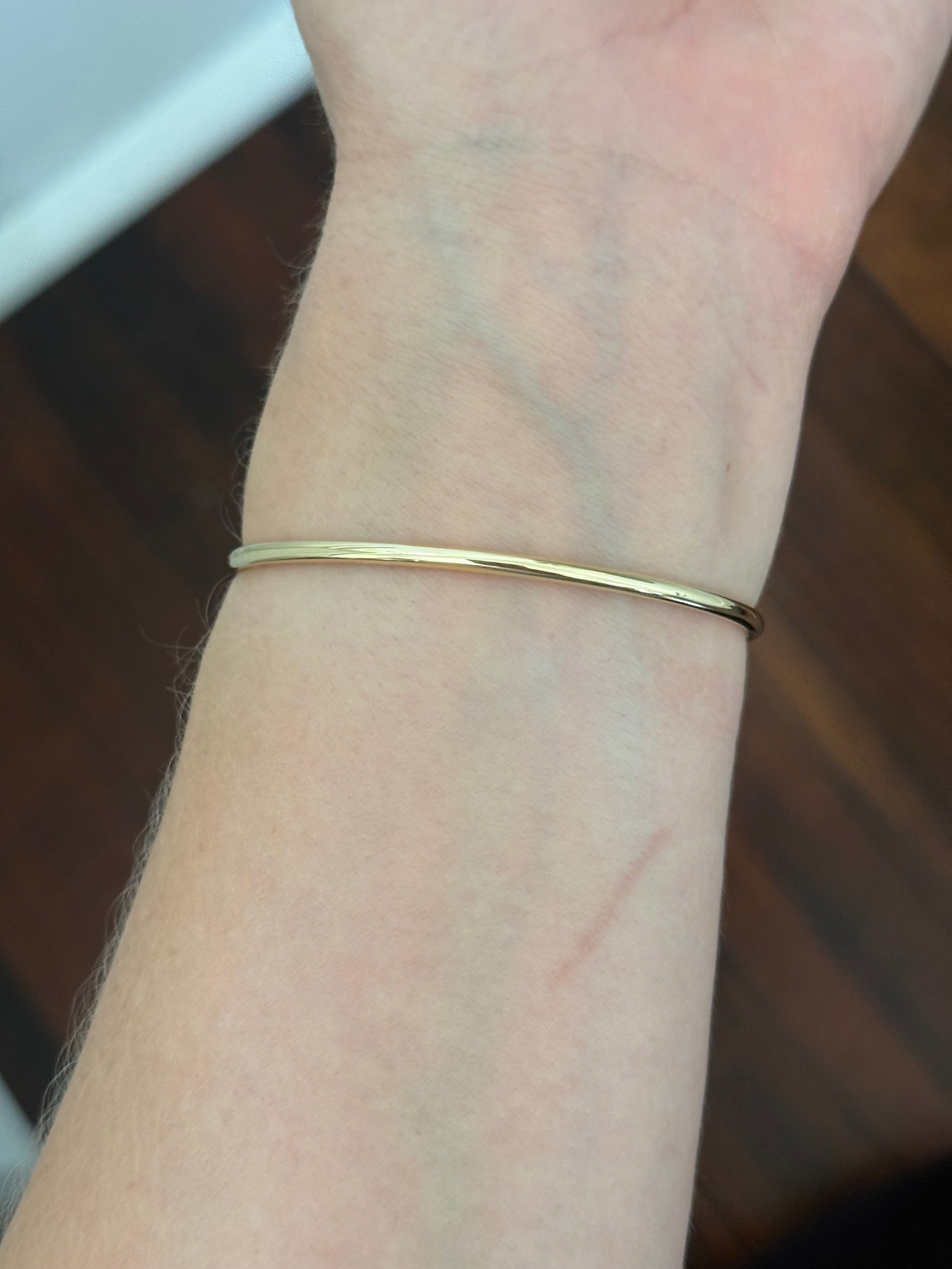 Yellow gold oval lab diamond bracelet. Lab diamond are bezel set in white gold