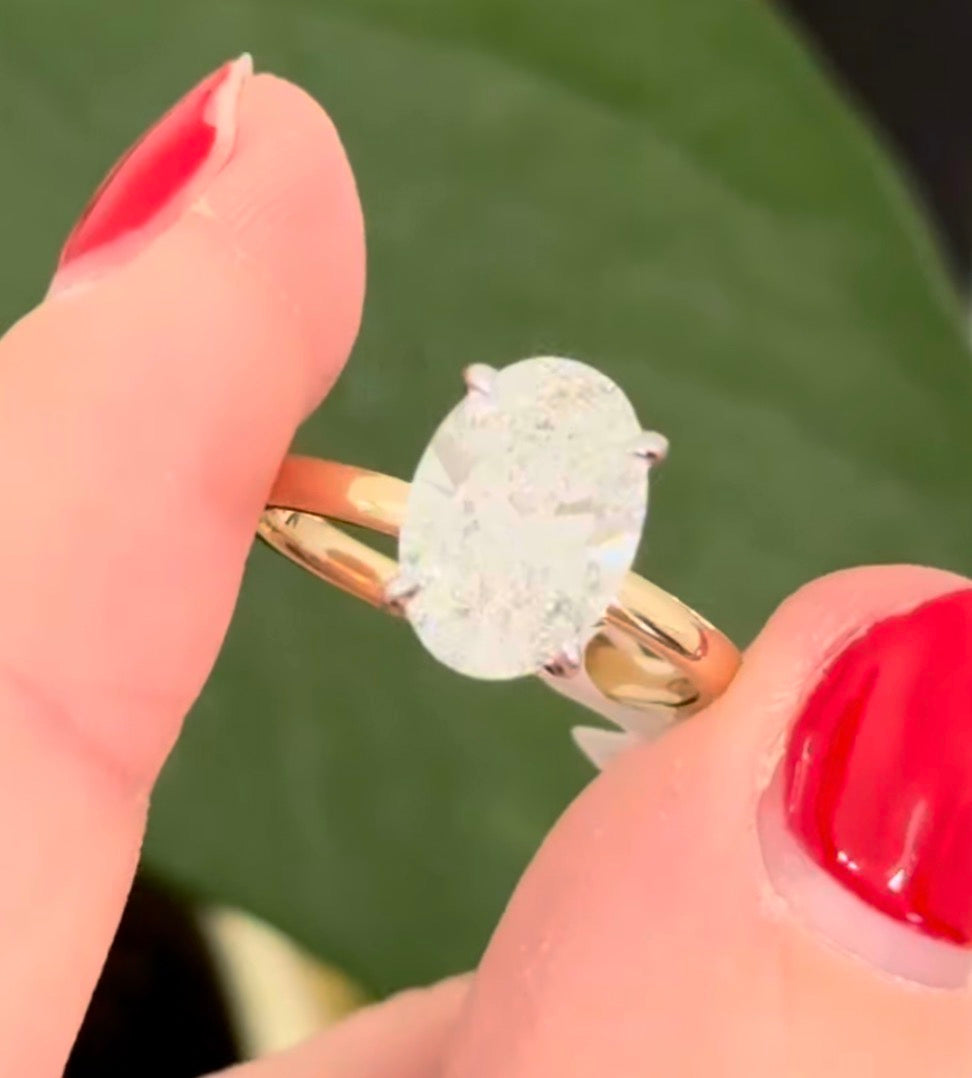 Yellow gold IGI certified oval lab diamond ring. Lab diamond is set in white gold