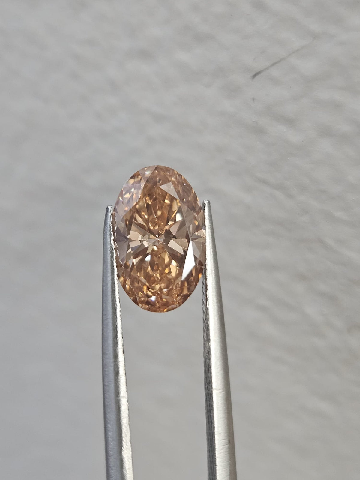 IGI 1.51CT OVAL FANCY PINKISH BROWN VS2