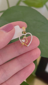 Yellow gold heart and bird pendant with pear shape and round lab diamonds