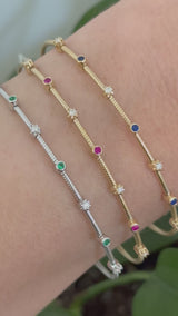 Natural diamond flex bracelets available in yellow gold with sapphires, yellow gold with rubies, and white gold with emeralds